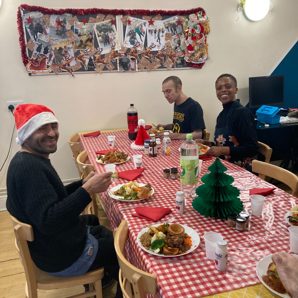 Group of three people enjoying their Christmas dinner.
