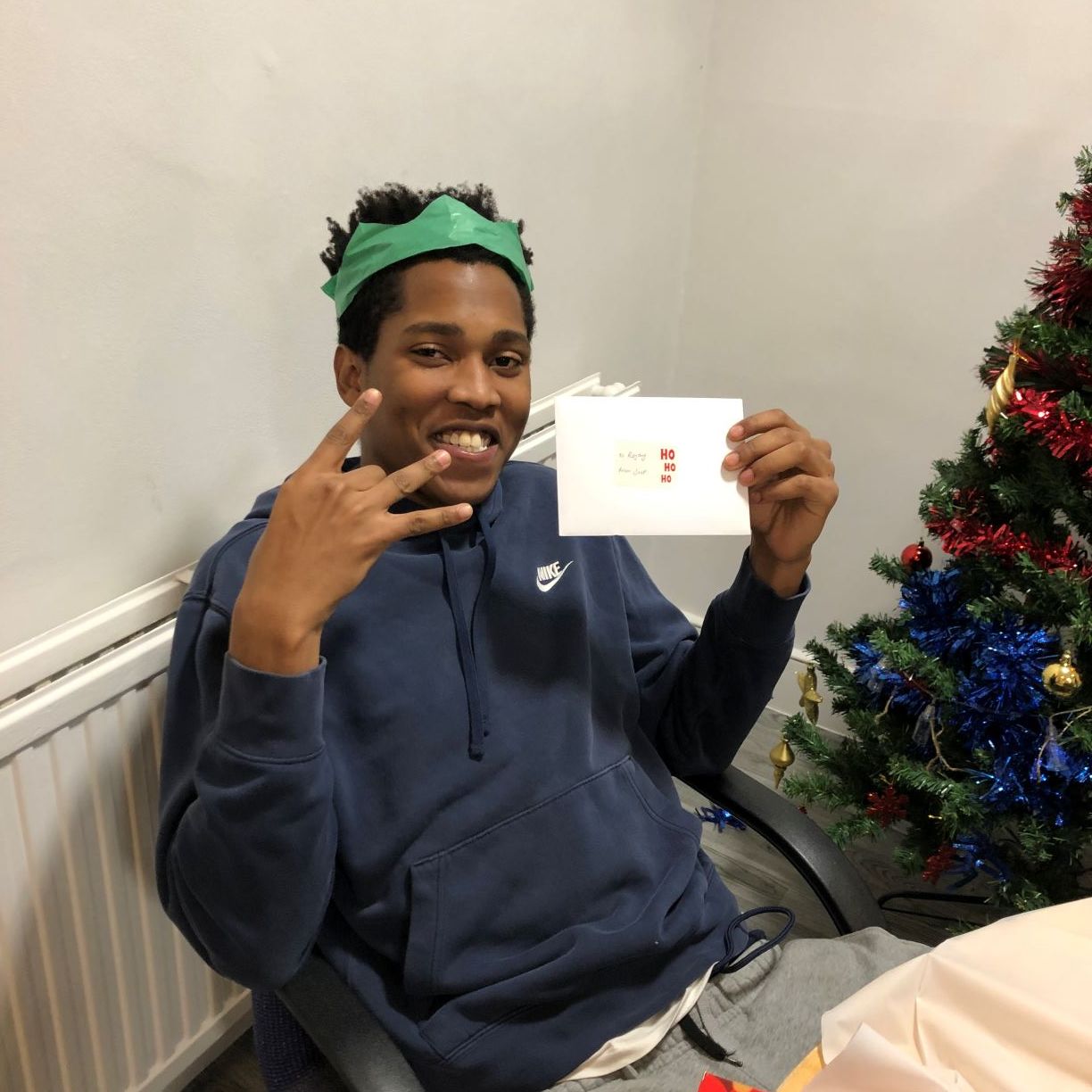 Young man holding a Christmas card.