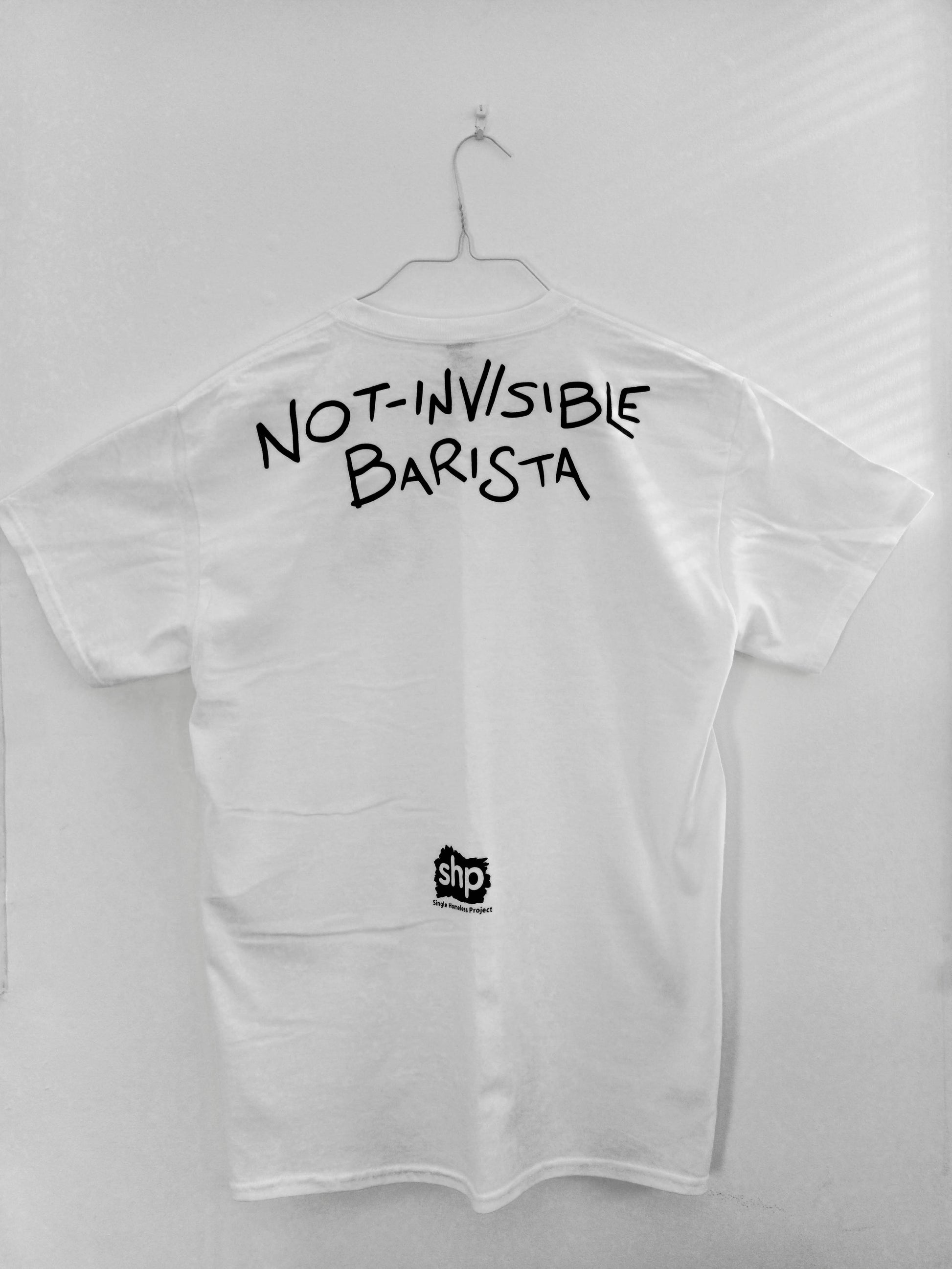 White t-shirt with "not-invisible barista" and SHP logo on the back.
