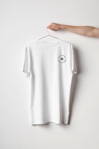 Front of the Invisible Coffee white t-shirt with the logo in the top right corner.